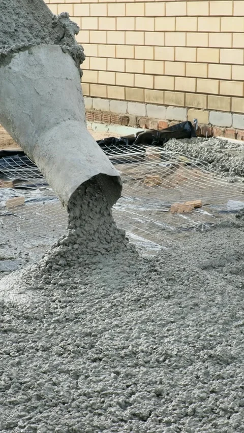 Close-up of wet cement being poured out on a construction site. Vertical video. Stock Footage 285583405