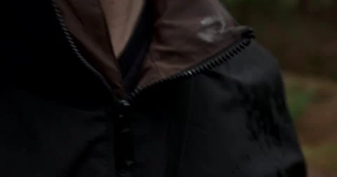 Close up of wet waterproof jacket with rain drops during forest hike Stock Footage 340839484