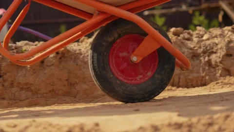Close up of a wheelbarrow moving on a construction site Stock Footage 341294870