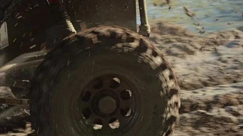 A close-up of the wheels of an SUV plowing through thick mud Stock Footage 344876005