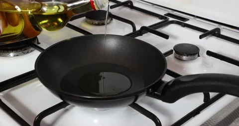 Close-up when olive oil is poured into a pan Stock Footage 211151387