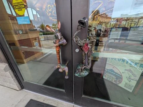 Close-up of whimsical rabbit and frog sculpted door handles Stock Photos