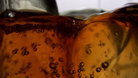 Close up of whiskey into ice cubes, slow motion. Stock Footage 72227901