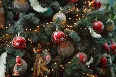 Close-up white and red christmas balls with a golden garland on christmas tre Stock Photos