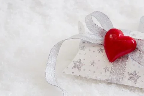 Close up of white and silver present box with red heart for christmas Stock Photos
