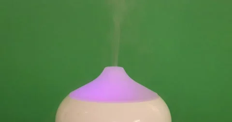Close-up of a white aroma oil diffuser humidifier that exhales aromatizing mist Stock Footage 201268712