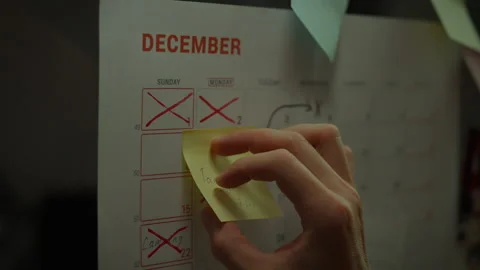 Close up of white asian man hand sticking note on week planning calendar. Go Stock Footage 281086985