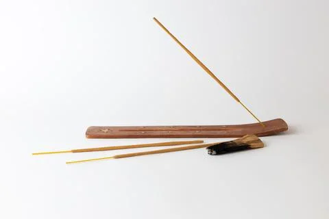 Close-up on a white background on a long brown stand with stars for incense Stock Photos