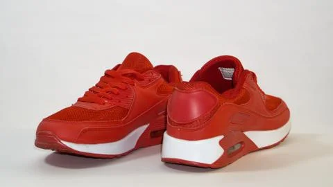 Close-up, on a white background, red sneakers, with white sole Stock Photos
