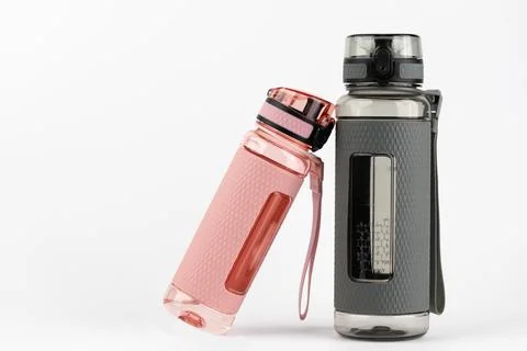 Close-up on a white background stands two plastic pink and gray rubberized Stock Photos