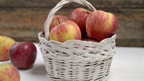 Close up of white basket with red apples on table white wood. Dolly motion Stock Footage 72117227