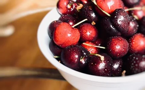 Close up of white bowl with red cherries Stock Photos