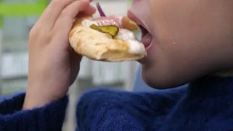 Close-up of a white boy, 4-5 years old, holding pizza in his hands Stock-Footage 288128455