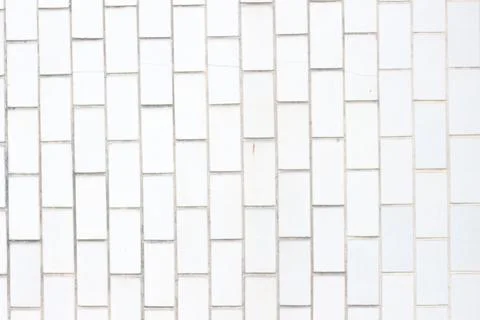 Close up of a white brick pattern wall with rectangular tiles and subtle grou Stock Photos
