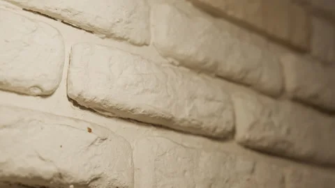 Close up white brick wall texture with soft lighting and shallow depth of field Stock Footage 344870850
