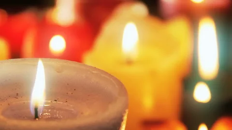Close-up of White Candle Flame with Vibrant Warm Bokeh Background Stock Footage 335884108
