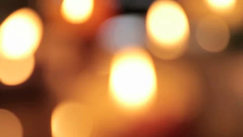 Close-up of White Candle Flame with Vibrant Warm Bokeh Background Stock-Footage 335884128