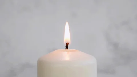 Close-up white candle light. White candle Fire Wick dancing at white background Stock Footage 127283611