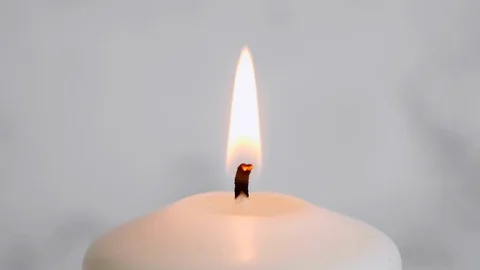 Close-up white candle light. White candle Fire Wick dancing at white background Stock Footage 127283655