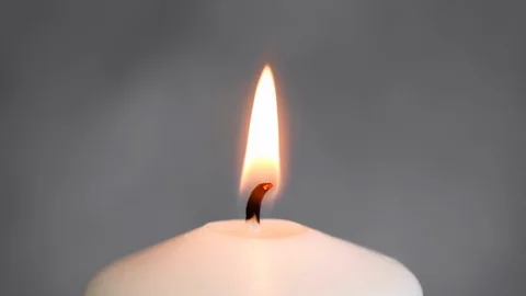 Close-up white candle light. White candle Fire Wick dancing at gray background Stock Footage 127283751