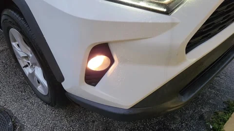 Close-up of white car LED headlight and fog light turned on Stock Footage 327067288