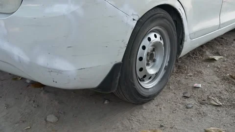 Close up of white car rear wheel moving on roadside Vidéo 333227968