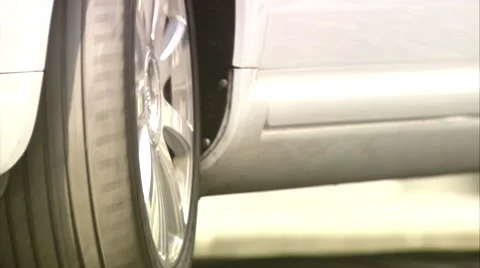 Close up of a white car with silver wheels parking/driver's shoes, high heels  Stock Footage