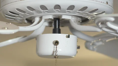 Close up of a white celing fan spinning up to speed. Stock Footage 99079162