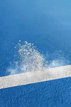 Close-up of white chalk powder exploding into the air as a tennis ball stri.. Stock Photos