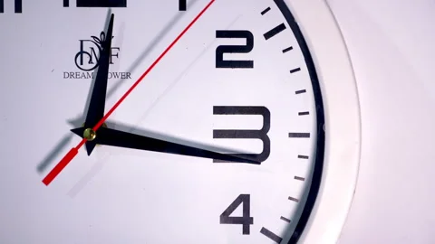 Close-Up of a White Circular Clock With a Red Second Hand on White Видео 337399631