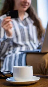 Close up white coffee cup on table in cafe, on blurred background of smiling Stock Photos