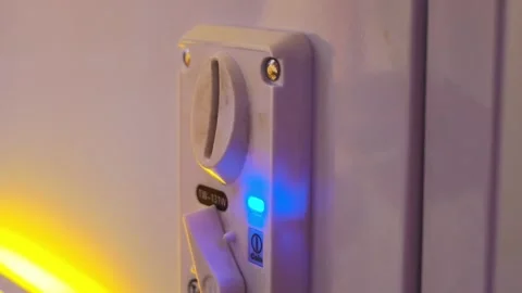 Close-up of White Coin Slot Switch with Blue LED Light 库存影片 340471953