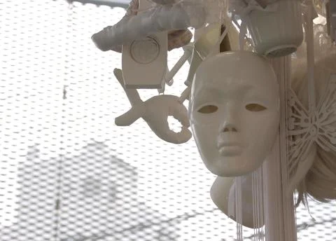 Close-up of a white colored mask on an expanded metal background Stock Photos