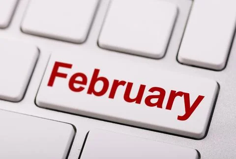 A close-up of a white computer keyboard key labeled "February" in red, symb.. Stock Photos