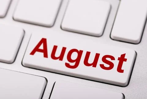 Close-up of a white computer keyboard with a red "August" key, representing.. Stock Photos