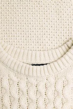 Close-up of a white cozy cable knitted sweater Stock Photos
