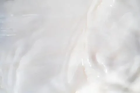 Close-up of white creamy texture with soft waves Stock Photos