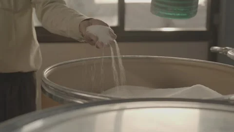 Close-up of white crystalline powder falling from a hand Stock-Footage 327633143