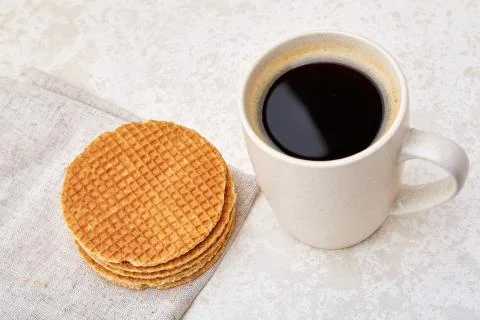 Close-up white cup of coffee with waffles on white background, top view Stock Photos