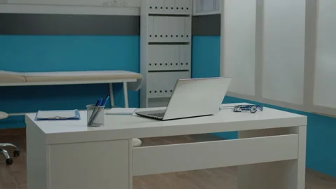 Close up of white desk in empty doctors office at healthcare clinic Stock Footage 158614157