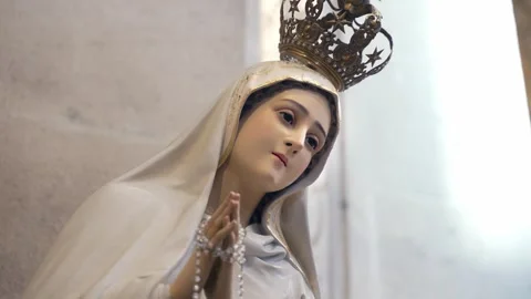 Close-up of white-dressed Virgin Mary statue in church, faith and devotion Stock-Footage 247040583