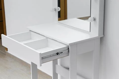 Close-up of a white dressing table with an open drawer. Stock Photos