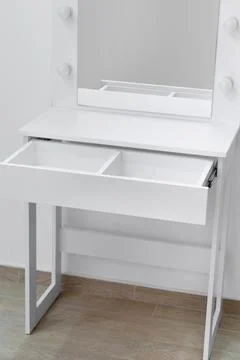 Close-up of a white dressing table with an open drawer. Stock Photos