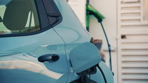 Close up of a white electric car connected to a charging station Stock Footage 325719353