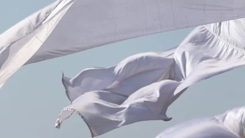 Close-up of white fabric flowing in wind against clear sky Stock Footage 331276874
