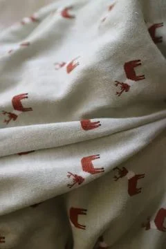 Close-up of white fabric with small red bear patterns Stock Photos