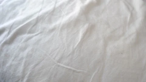 Close-Up of white feather flying on the bed Stock Footage 150259389