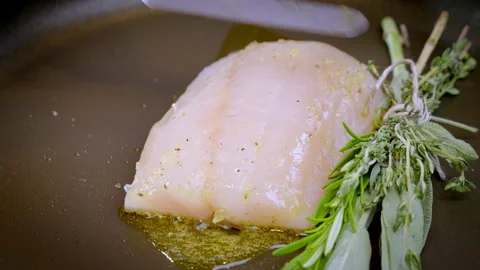 Close-up of white fish, pike perch, frying in a hot pan. Slow motion video. Stock Footage 302646126