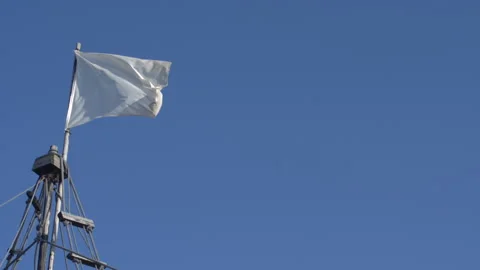 Close Up Of White Flag On Top Of A Boat. Blue Sky. Slow Motion Stock Footage