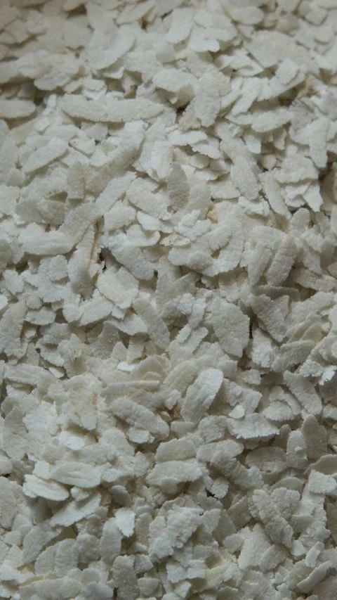 Close-up of white flattened rice flakes Видео 330658016